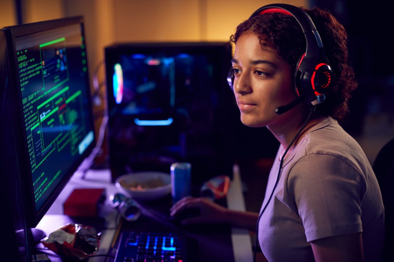 female-teenage-hacker-sitting-in-front-of-computer-screens-bypassing-cyber-security.jpg - Mass Global Media - Mass Global Media